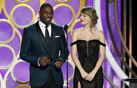 Idris Elba and Taylor Swift presenting an award.
